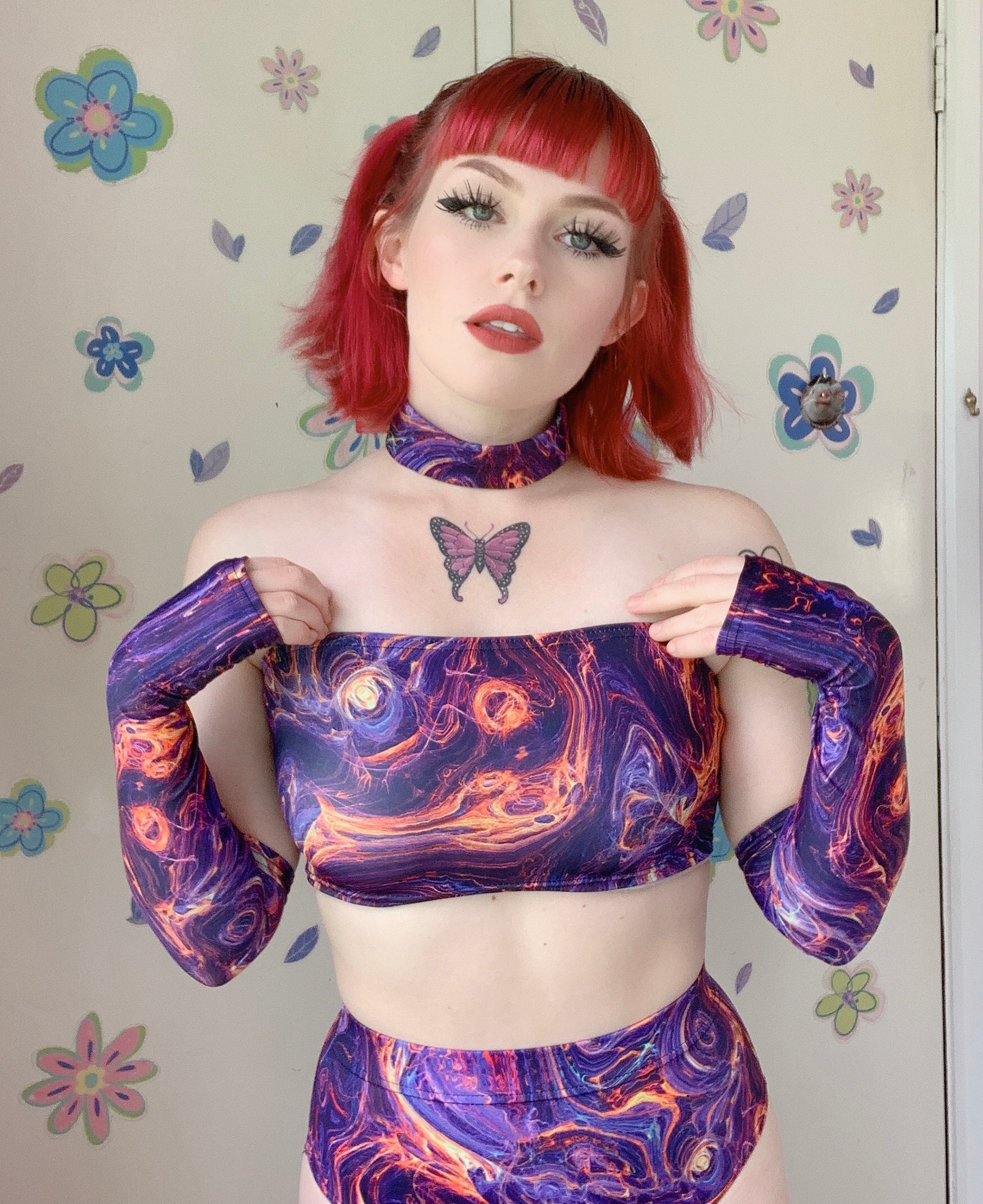 redhead girl with butterfly tattoo wearing rave outfit choker tube top with arm warmers