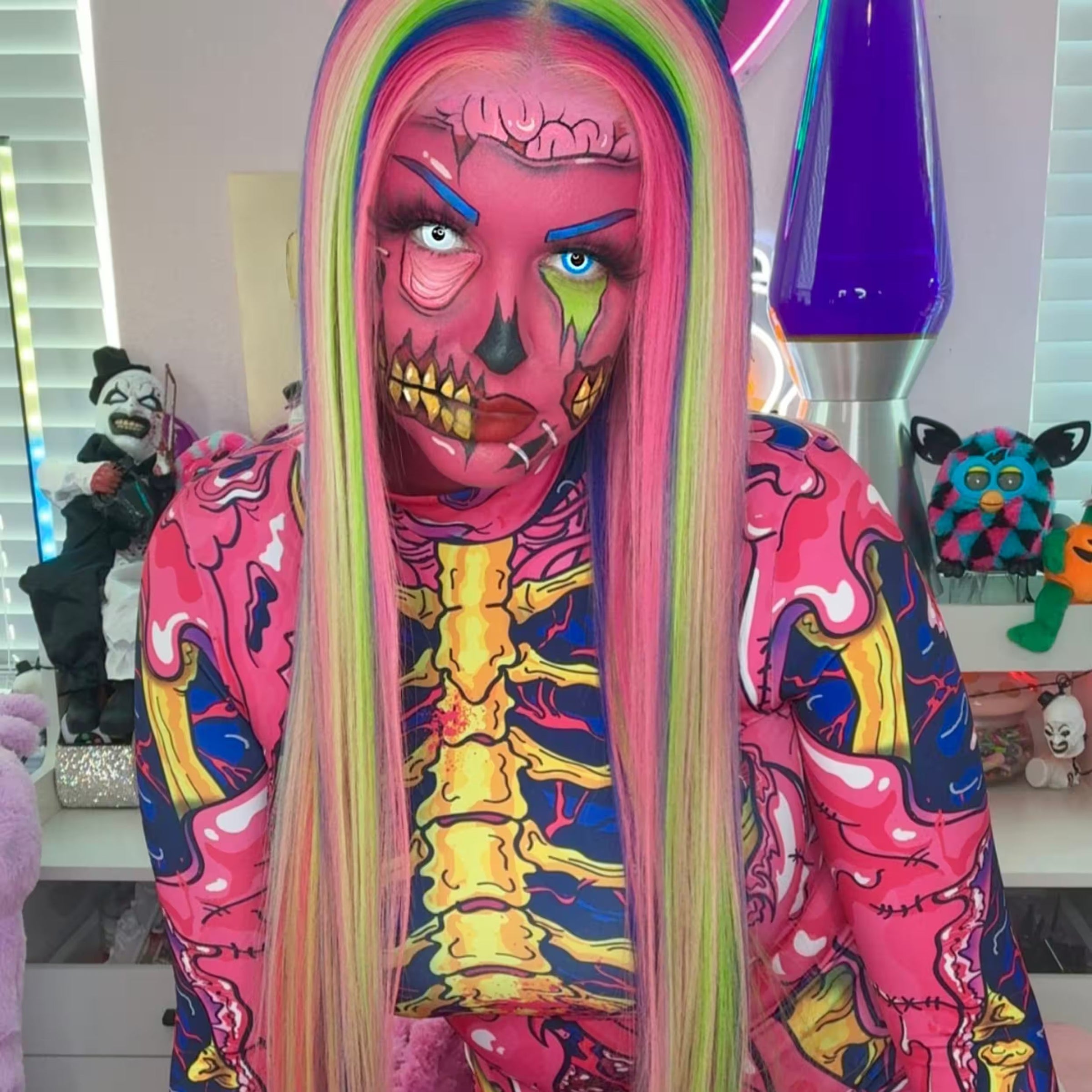 Woman wearing a bright pink zombie skeleton Halloween costume with neon rainbow hair and detailed horror makeup, a colorful rave outfit idea for MÁS EDM New Orleans.