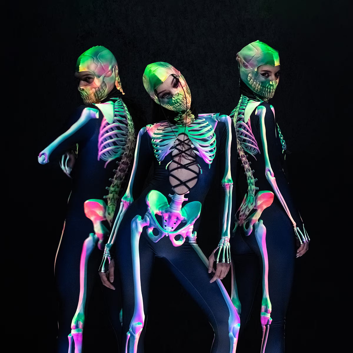 Three women wearing neon skeleton bodysuits and matching skull masks, styled as Halloween rave outfits for SCREAM Edmonton.